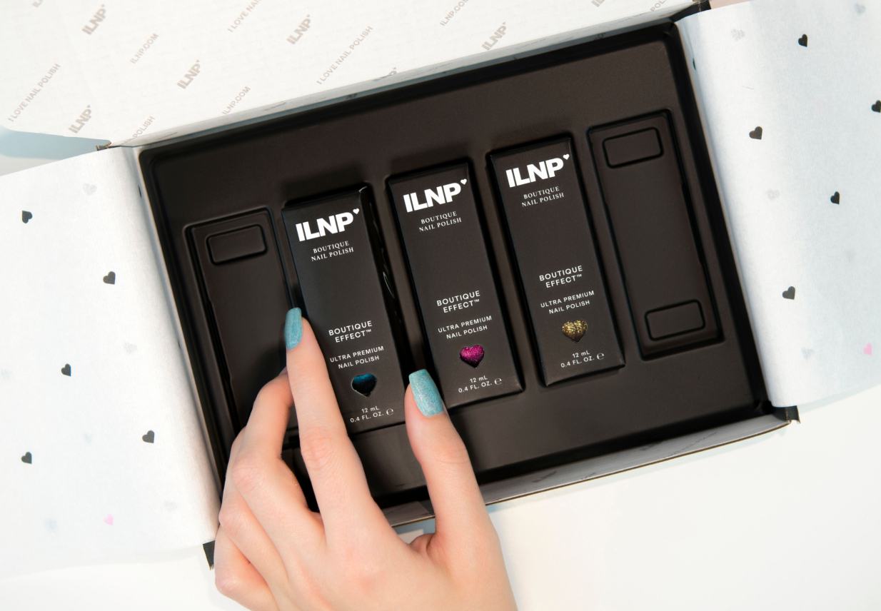 An open ILNP Boutique Effect gift box containing three nail polish bottles